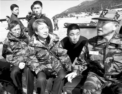 28日，在韩国白翎岛，总理郑云灿（前左二）坐橡皮艇查看“天安”号沉没地点。 图/人民图片